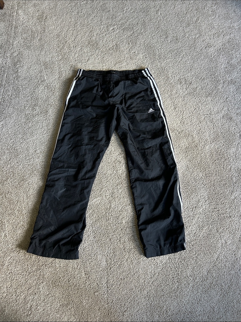adidas Black Jogger Pants with White Side Stripes pockets in the front and zips